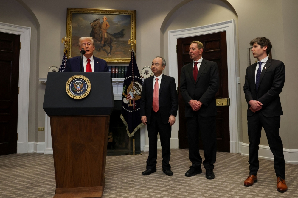US President Donald Trump delivers remarks on AI infrastructure, next to Oracle co-founder Larry Ellison, SoftBank CEO Masayoshi Son and OpenAI CEO Sam Altman at the Roosevelt room at White House in Washington January 21, 2025. — Reuters pic  