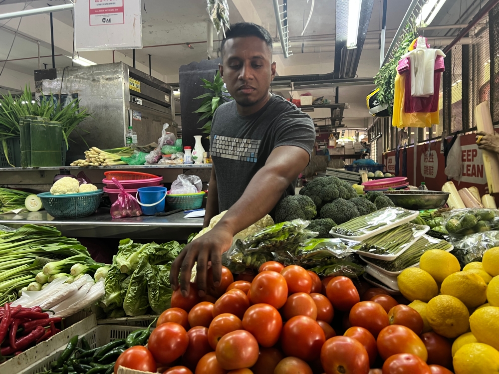 Dinesh Kumar, a trader at Batu Lanchang market, noted that the price of tomatoes has more than doubled in the past two weeks. — Picture by Opalyn Mok