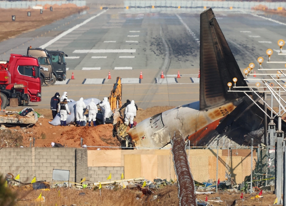 Jeju Air flight 2216 was carrying 181 people from Thailand to South Korea on Dec 29, 2024, when it issued a mayday call and belly-landed before hitting a barrier and bursting into flames, killing everyone aboard except two flight attendants pulled from the burning wreckage. — Pic by AFP