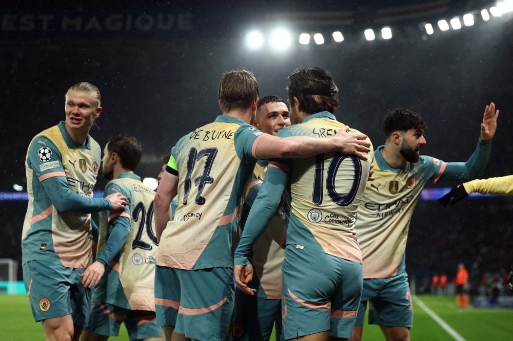 Manchester City’s Jack Grealish (second from right) is congratulated by teammates after scoring. — Pic by AFP