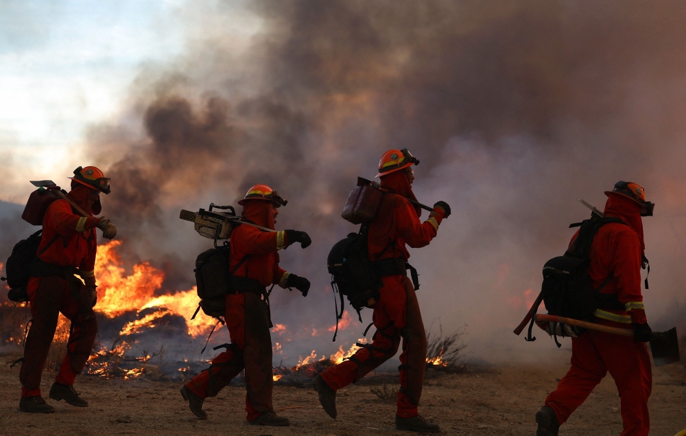 Inmate firefighters work as the Hughes Fire burns north of Los Angeles. — Pic by AFP