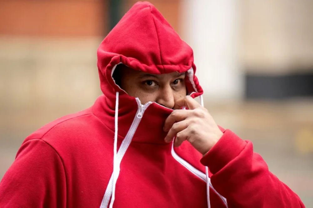 A defendant arrives at court in Manchester ahead of the trial of eight men accused of rape and sexual exploitation of two girls. — Pic by AFP