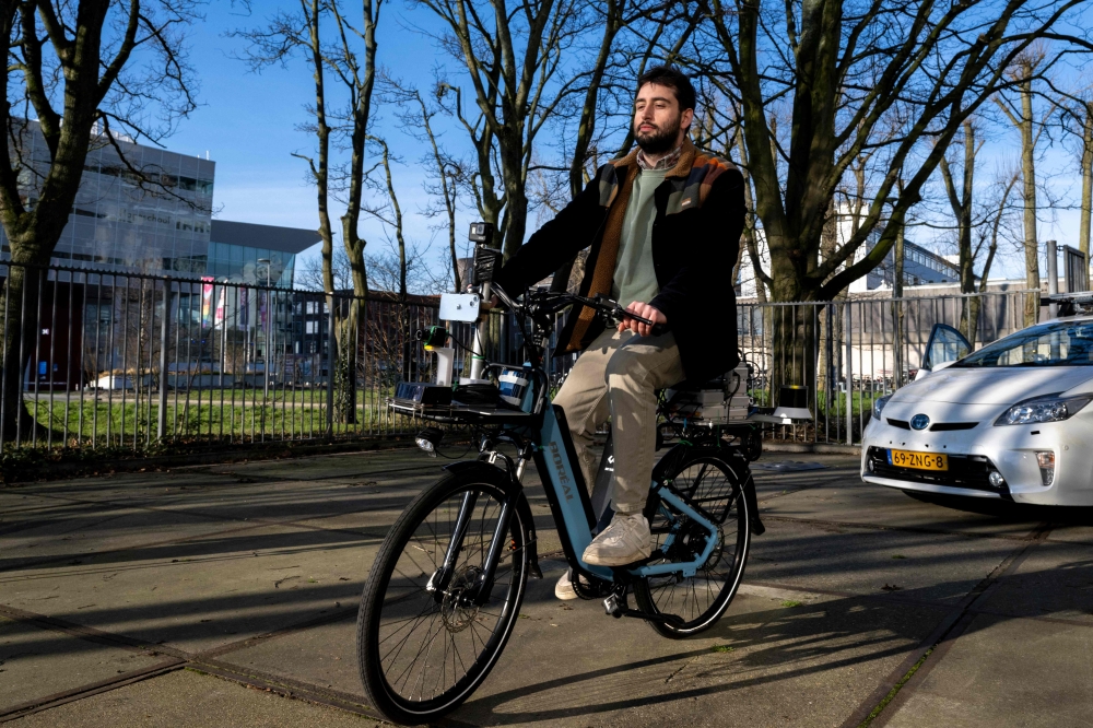 Denniz Goren, robotics masters student at the Mechanical Engineering Faculty at Delft University of Technology (TU Delft) demonstrates a TU Delft SenseBike in Delft on January 13, 2025. — AFP pic 