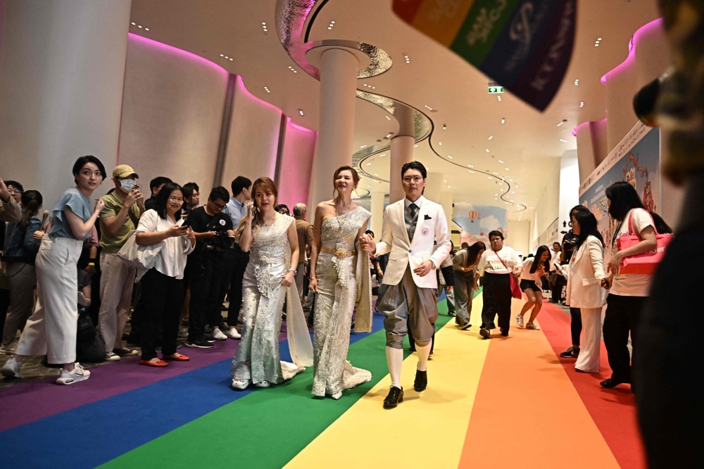 Couples attend a marriage registration event at Paragon shopping mall in Bangkok on January 23, 2025. — AFP pic
