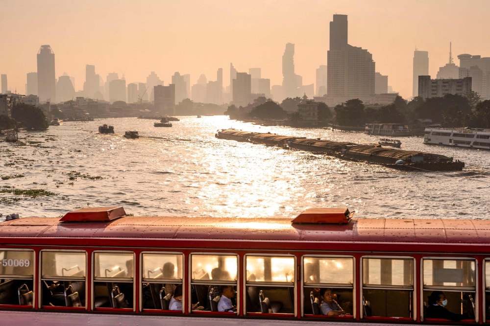 A bus drives on a bridge over the Chao Phraya river amid high air pollution levels in Bangkok on January 21, 2025. — AFP pic 