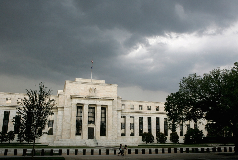 Early summer storm clouds gather over the U.S. Federal Reserve Building before an evening thunderstorm in Washington June 9, 2006. — Reuters pic