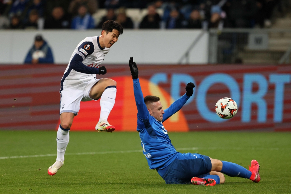 Tottenham Hotspur's South Korean striker Son Heung-Min (left) scores his team's second goal past Hoffenheim's German goalkeeper Oliver Baumann. — AFP pic
