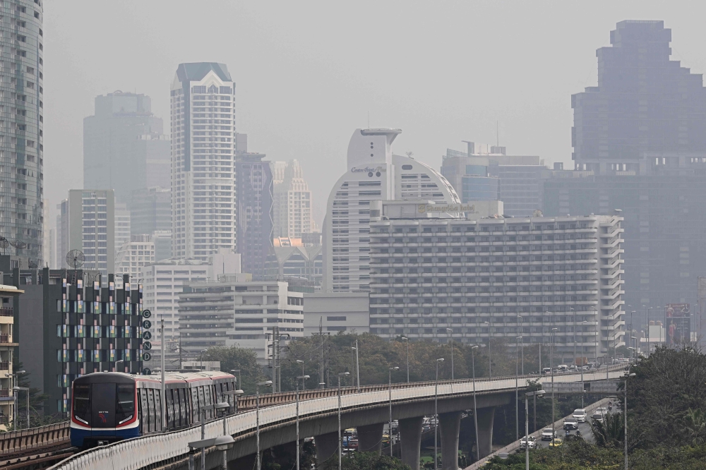 A BTS Skytrain runs along its tracks amid high levels of air pollution in Bangkok January 24, 2025. Bangkok officials announced free public transport for a week in a bid to reduce traffic in a city notorious for noxious exhaust fumes. — AFP pic
