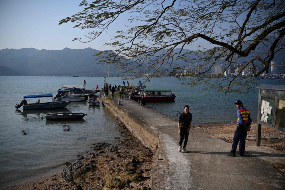 People visit the village of Kuk Po in northern Hong Kong near the China border on January 18, 2025. The seaside Kuk Po village was once home to Hakka people from southern China but was mostly abandoned in recent decades, even as gleaming high-rises sprang up in nearby Shenzhen across the Chinese border. — AFP pic
