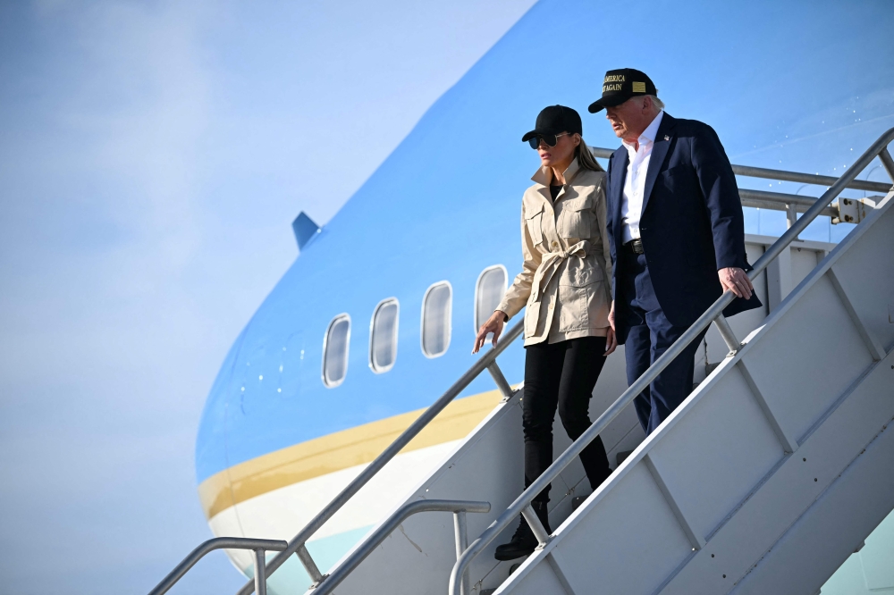 US President Donald Trump and First Lady Melania Trump step off of Air Force One upon arrival at Los Angeles International Airport to visit the region devastated by the Palisades and Eaton fires. — AFP pic