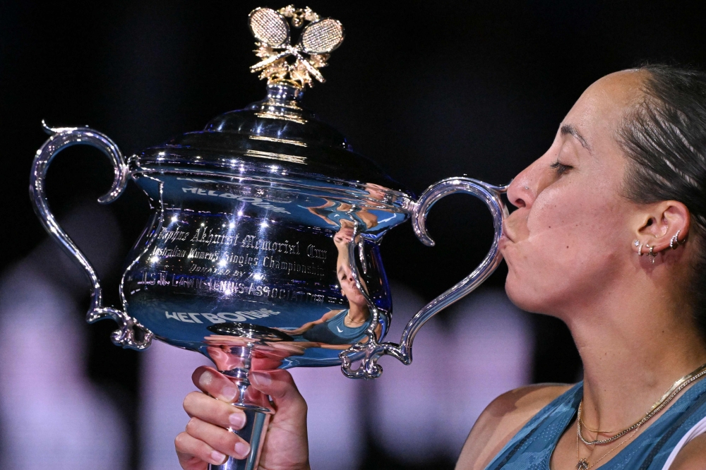World 19th seed kisses the Australian Open tennis trophy after winning her first Grand Slam title in defeating Number One Aryna Sabalenka on January 25, 2025. — AFP pic