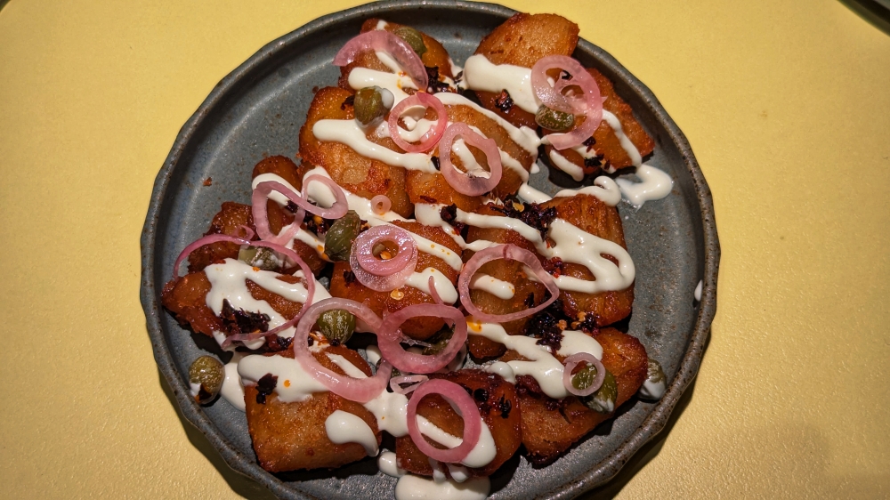 Triple-cooked Potato comes with capers, pickled shallots and feta cream. — Picture by Ethan Lau