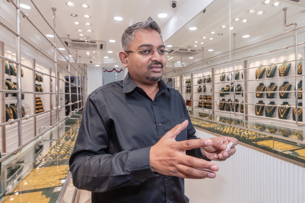 Datuk Vikness Raju, owner of Lalal Gold and Kanika Gold jewellery stores, explains the symbolism of the different wedding ‘thali’ to Malay Mail. — Picture by Raymond Manuel