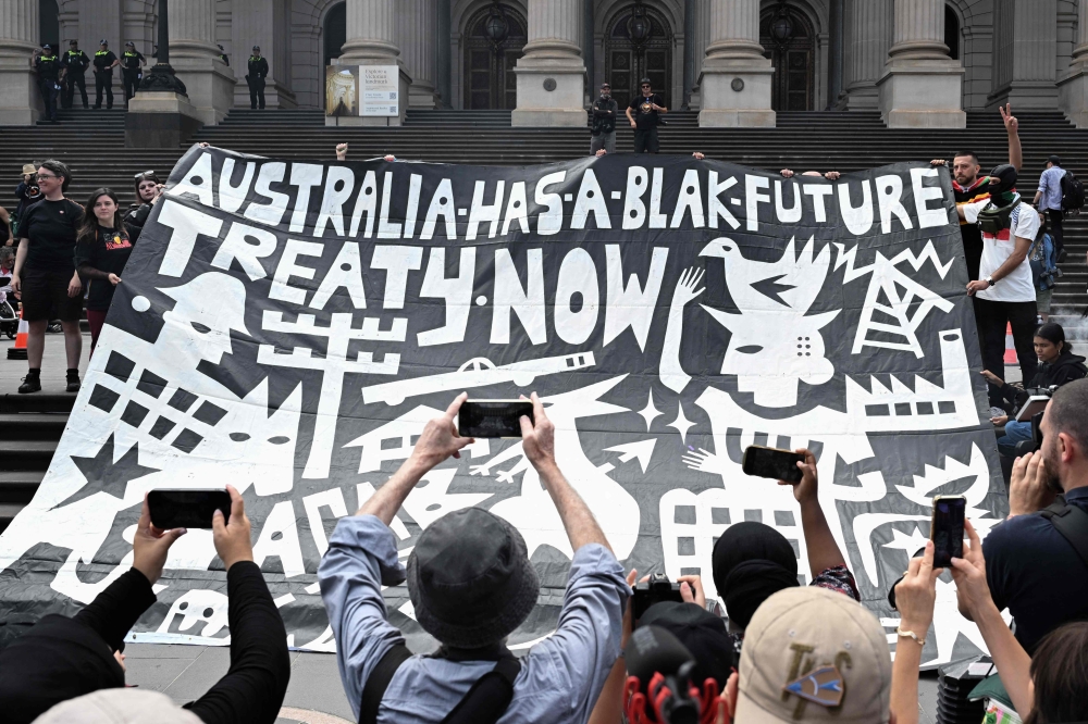 Demonstrators unfurl a banner as they take part in the annual “Invasion Day” protest march through the streets of Melbourne on Australia Day on January 26, 2025. — AFP pic