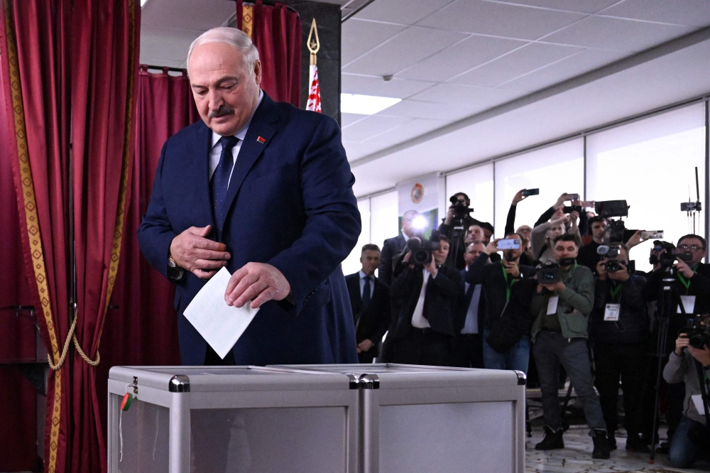 Belarusian President and presidential candidate Alexander Lukashenko casts his ballot yesterday. — AFP pic