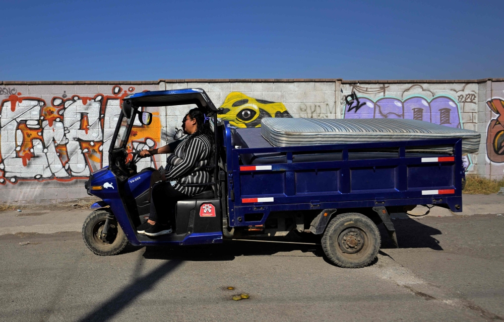 Maria del Mar Terron Martinez, 29, and her father Marco Antonio Terron, 59 ride their modified motorcycle in Acolman, Mexico. — Pic by AFP