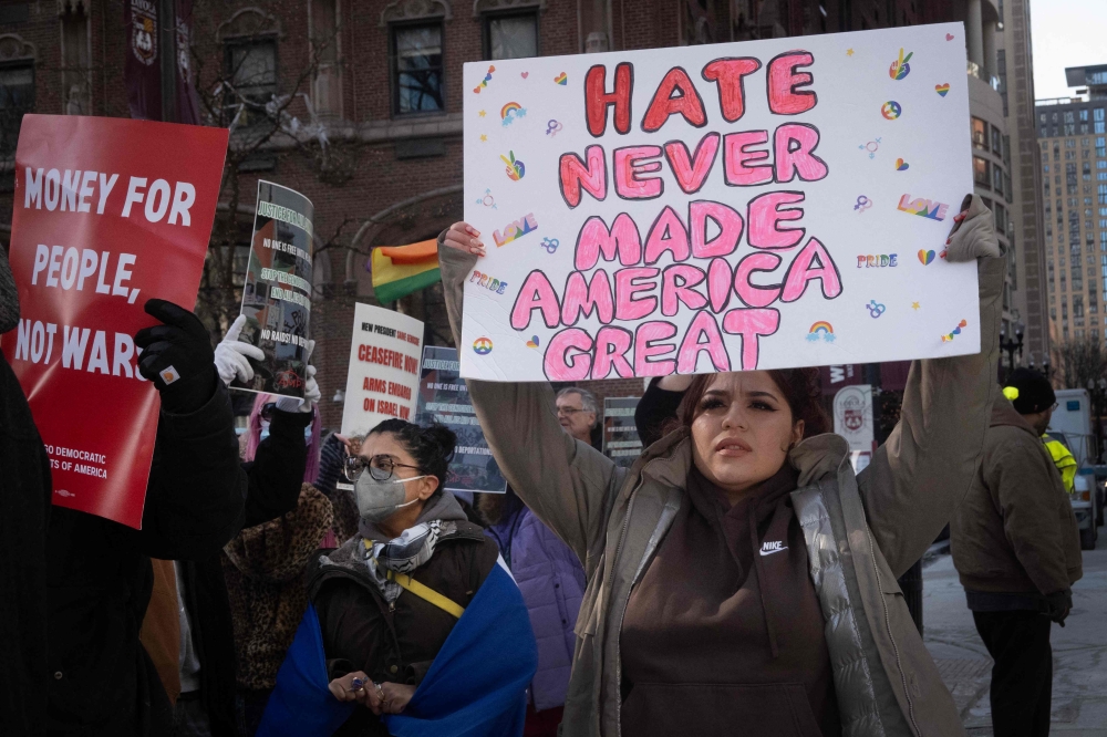 Activists protest the agenda of President Trump during a rally near the water tower on the Magnificent Mile on January 25. — Pic by AFP