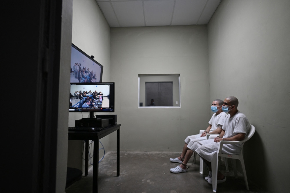 Two inmates watch a virtual trial at the Counter-Terrorism Confinement Centre (CECOT) mega-prison. — AFP pic 