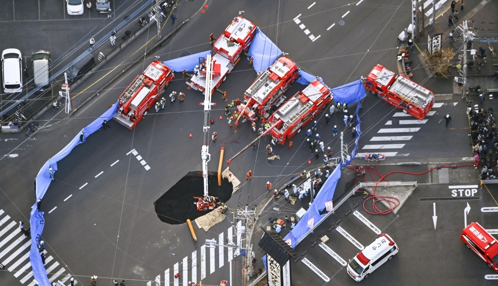 An aerial view shows rescue operations underway at a large sinkhole that swallowed a truck at an intersection in Yashio, north of Tokyo, Japan January 28, 2025, in this photo taken by Kyodo. — Kyodo handout pic via Reuters 