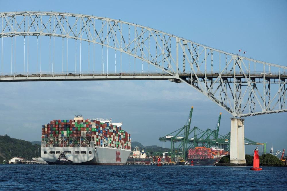 A cargo ship sails underneath the Bridge of the Americas, which spans the entrance to the Panama Canal in Panama City, Panama January 22, 2025. — Reuters pic 