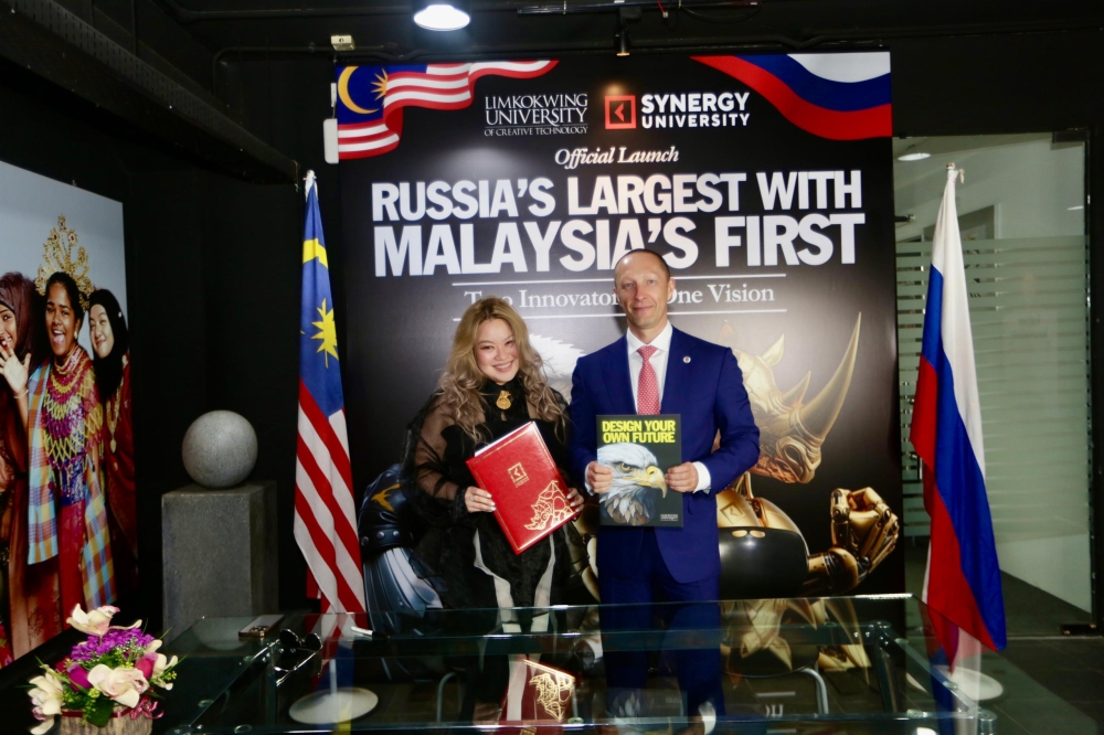 Tiffanee Marie Lim, Group Chief Brand Officer of Limkokwing University, and Vadim Lobov, President ofSynergy University, pose with the memorandum of understanding, symbolising their game-changing education partnership.