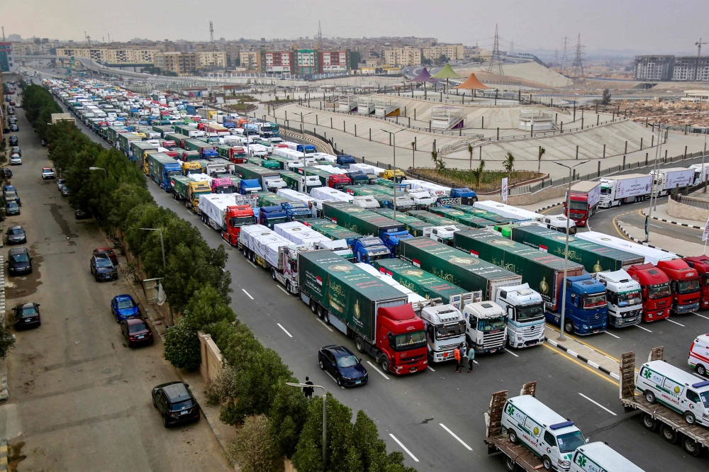 Trucks that are part of a humanitarian aid convoy carrying shipments to Palestinians in the Gaza Strip wait for the convoy to start moving in the Asmarat district in al-Muqattam on the southern outskirts of Cairo on January 26, 2025. — AFP pic
