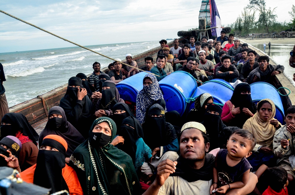 Newly-arrived Rohingya refugees look on from their boat after authorities prevented the refugees from disembarking and ordered them to remain on board the vessel, at Leuge Beach in Indonesia's Aceh province on January 29, 2025. — AFP pic