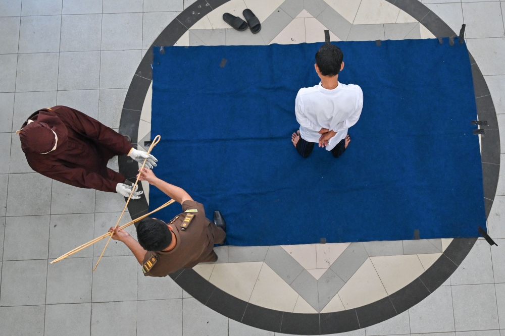Four men were flogged in Indonesia’s conservative Aceh province on Thursday for engaging in online gambling, local officials said. — AFP pic