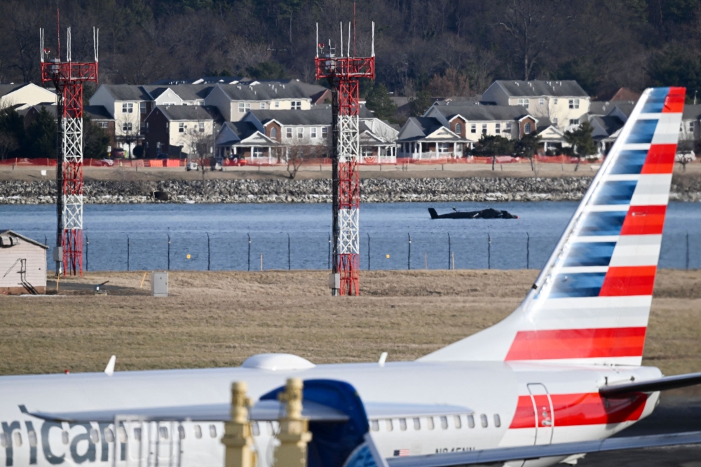 Part of the wreckage is seen along the Potomac River after American Airlines flight 5342 on approach to Reagan National Airport crashed into the river after colliding with a US Army helicopter. — Pic by AFP
