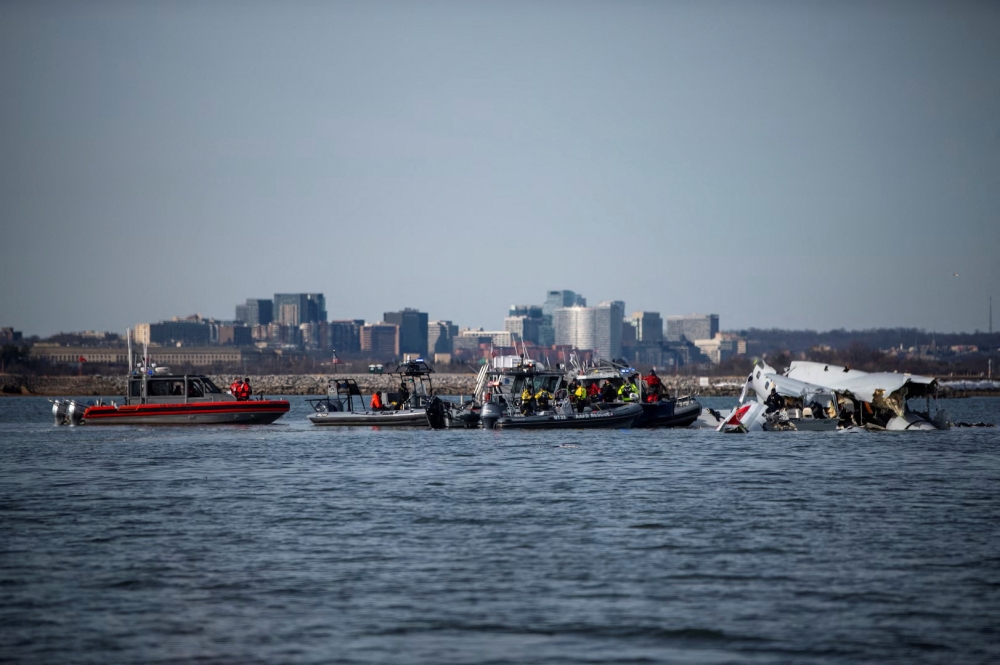 US Coast Guard, along with other search and rescue teams, operate near debris in a location given as Washington, in the aftermath of the collision of American Eagle flight 5342 and a Black Hawk helicopter that crashed into the Potomac River, in this handout release on January 30, 2025. — US Coast Guard handout pic via Reuters 