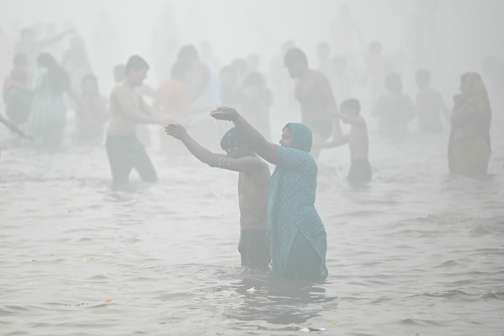 Hindu pilgrims take part in a bathing ritual in Sangam during the Maha Kumbh Mela festival, in Prayagraj. — AFP pic