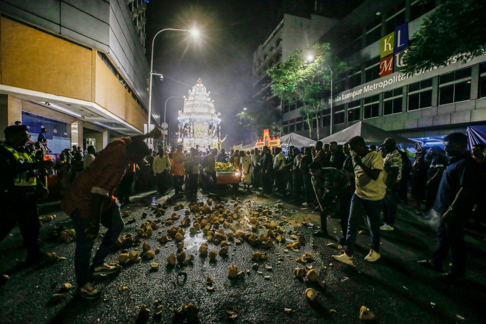 Hindu devotees breaking coconuts in front of a chariot procession heading from Sri Maha Mariamman Temple in Kuala Lumpur to Batu Caves during Thaipusam on February 4, 2023. — File picture by Hari Anggara