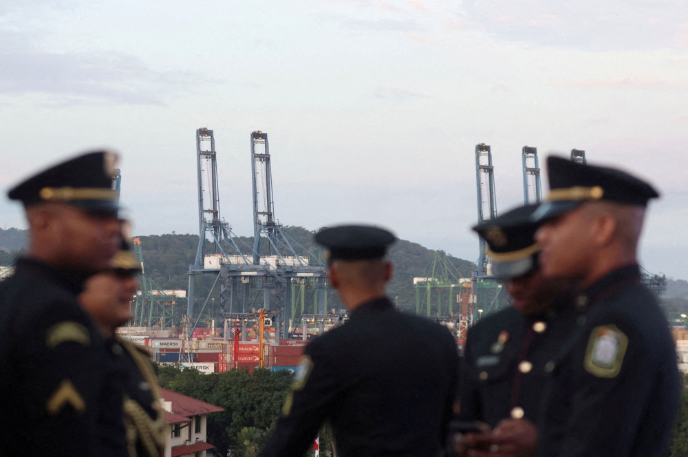 Institutional security officers stand as cranes are seen in the background during a ceremony to celebrate the 25th anniversary of the United States ceding control of the Panama Canal to the government of Panama in 1999, in Panama City, Panama, December 31, 2024. — Reuters pic