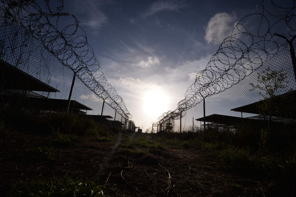This photo made during an escorted visit and reviewed by the US military, shows the razor wire-topped fence at the abandoned 