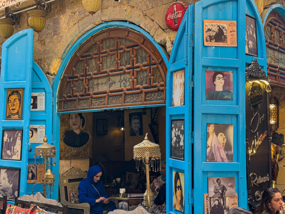 People sit at the Umm Kulthum cafe, named after the late Egyptian singer, songwriter and film actress in the Khan al-Khalili historical area in the heart of the Egyptian capital Cairo on January 28. — AFP pic