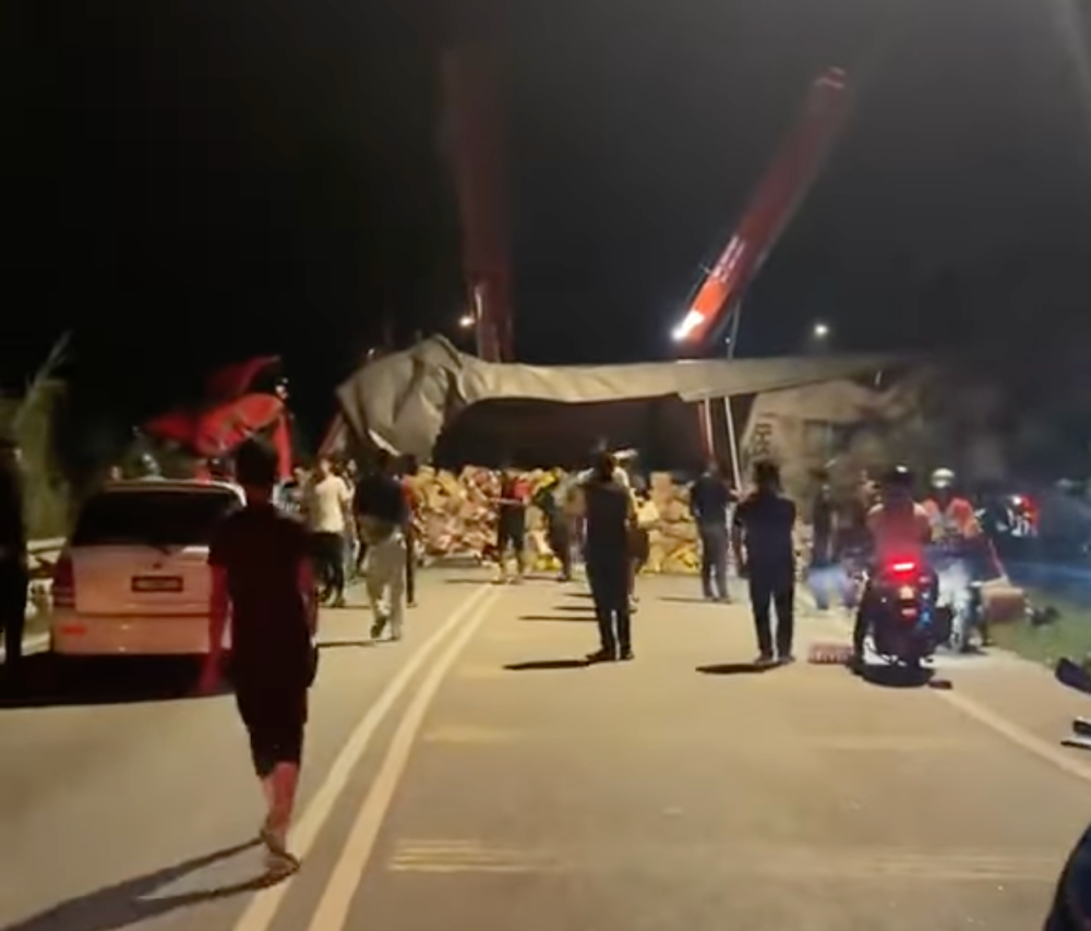 A screengrab from video of the Scania trailer, which overturned after it collided with the victims’ Perodua Myvi.