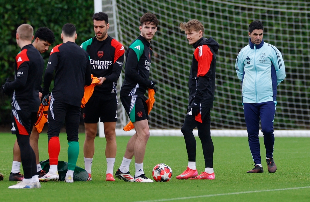 Arsenal's Mikel Merino, Declan Rice and Martin Odegaard with manager Mikel Arteta during training. — Reuters pic