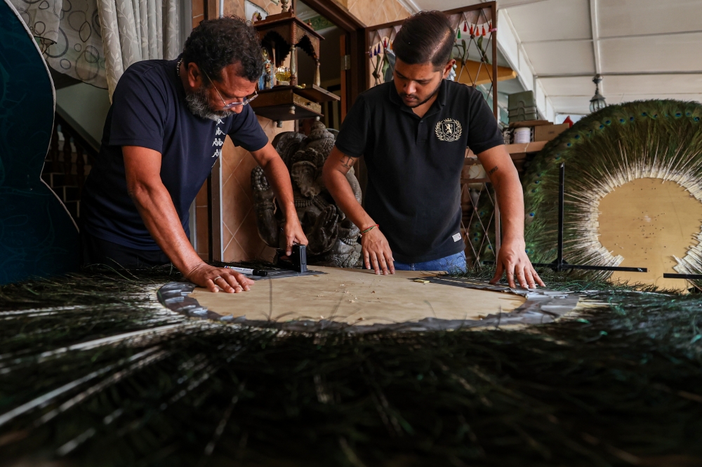 Kavadi artisan K. Sevaraja (right) with assistant Dinesh Rao Letchumanan (left) during the kavadi crafting process in Kajang February 2, 2025. — Bernama pic