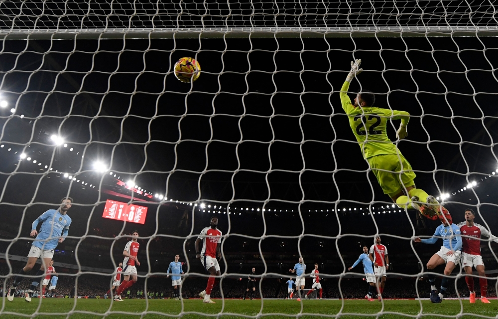 Manchester City's Norwegian striker #09 Erling Haaland (2R) heads in their first goal during the English Premier League football match between Arsenal and Manchester City at the Emirates Stadium in London on February 2, 2025. — AFP pic