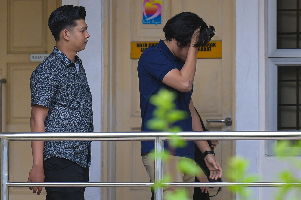 Zayn Rayyan’s father, Zaim Ikhwan (left), in court for the mention of the case in which he is charged with neglecting his autistic son, Zayn Rayyan Abdul Matin, in a manner likely to cause him physical harm, Kuala Lumpur, January 28, 2025. — Bernama pic 