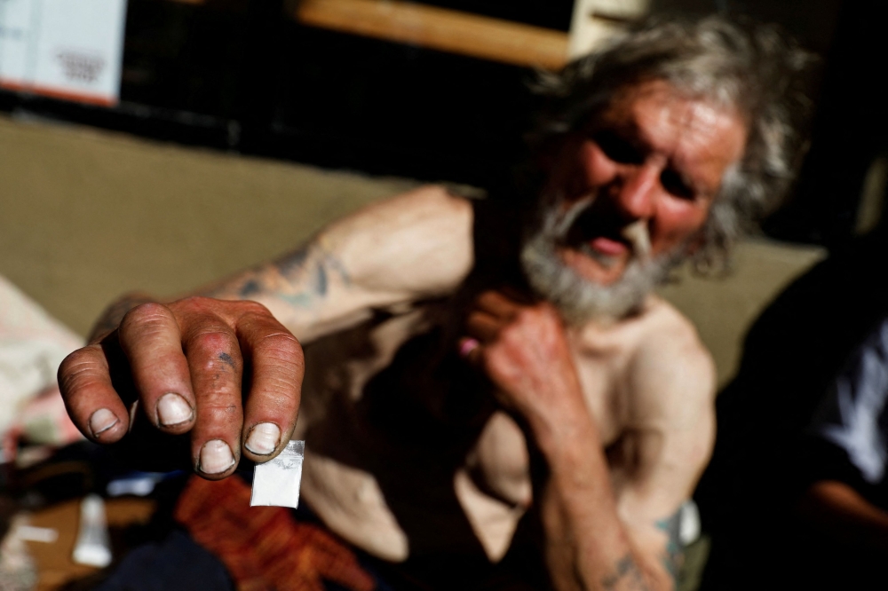 A man holds up a bag of fentanyl on the streets of San Francisco, California, US, February 27, 2020. — Reuters pic