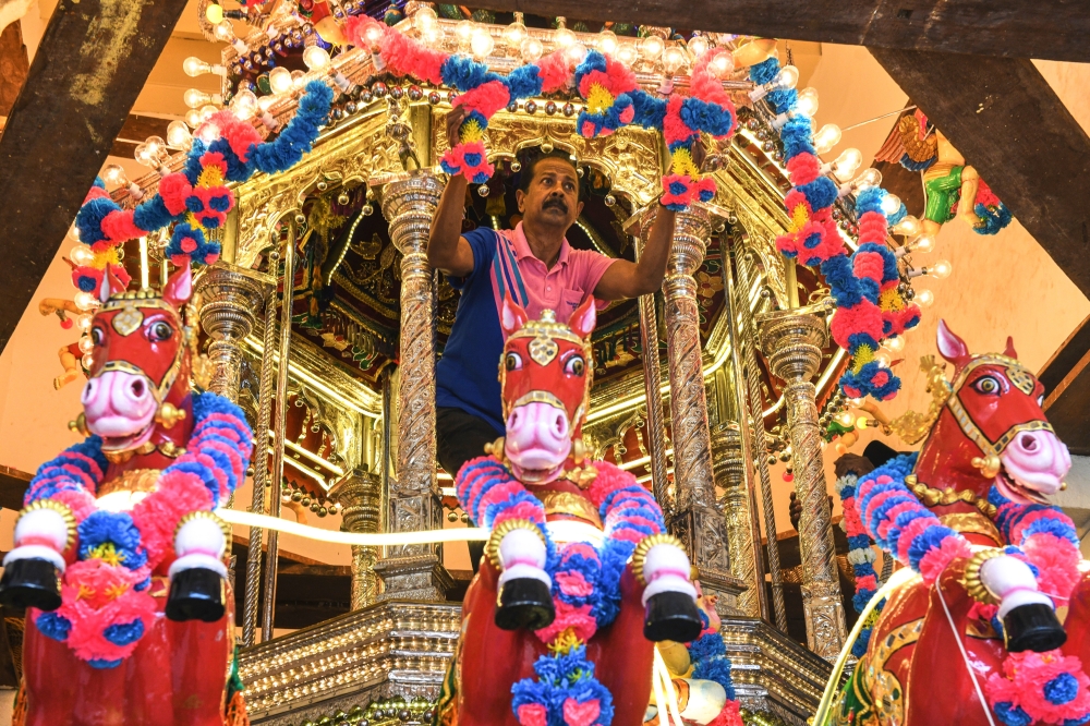 A volunteer at the Nagarathar Thanduthabani Temple decorates a 138-year-old silver chariot in George Town February 3, 2025, ahead of the Thaipusam celebration on February 11. — Bernama pic