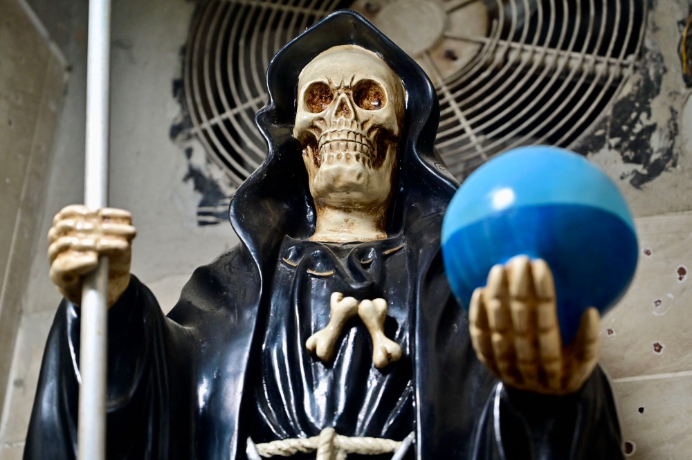 Santa Muerte — a Mexican death saint — adopted by local gangs as their own talisman is a skeleton shrouded in a cape with a scythe in her right hand and a globe of Earth in her left. — Pic by AFP