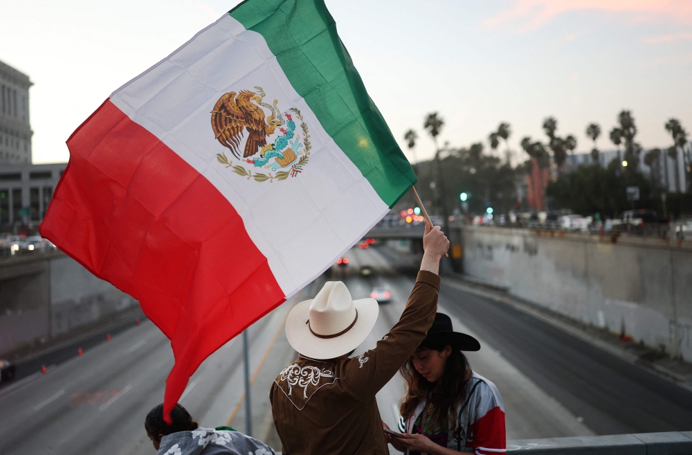 Asian equities rose with the Mexican peso and Canadian dollar today after Donald Trump said he would delay the imposition of tariffs on imports from the US neighbours. — Pic by AFP 