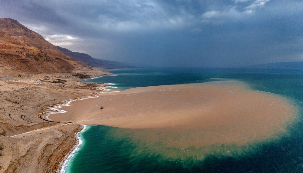 This aerial view shows a large brown muddy rainwater patch flowing into the Dead Sea from the Arugot Stream in the Judean Desert near Israeli Kibbutz Ein Gedi. — AFP pic