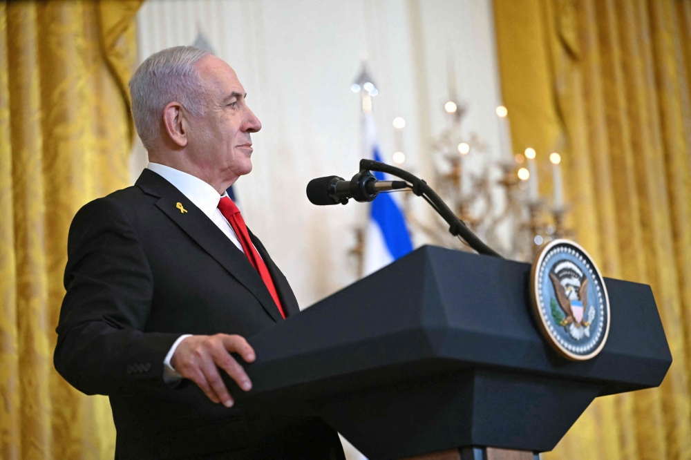 Israel's Prime Minister Benjamin Netanyahu listens during a press conference with unseen US President Donald Trump in the East Room of the White House in Washington, DC, on February 4, 2025. — AFP pic