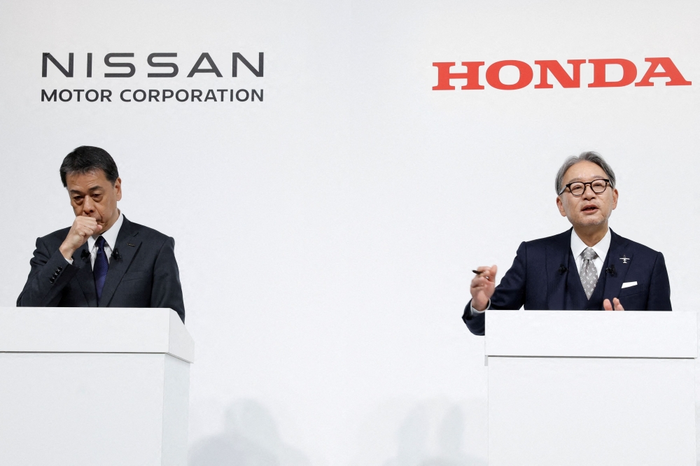 Makoto Uchida, Director, Representative Executive Officer, President and CEO of Nissan Motor Corporation and Toshihiro Mibe, Director, President and Representative Executive Officer of Honda, attend a joint press conference on their merger talks, in Tokyo, Japan, in December 2024. — Pic by Reuters