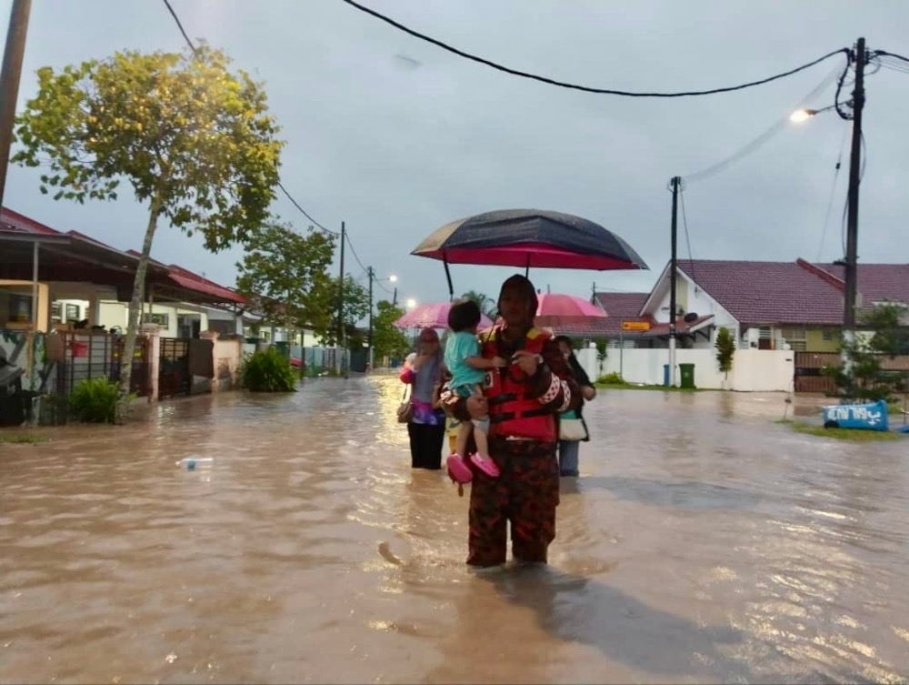 Residents from Taman Desaru Utama in Kota Tinggi who were evacuated and moved to a temporary flood relief centre (PPS) after parts of Kota Tinggi were inundated by flood waters after a continuous downpour earlier today, February 5, 2025. — Picture courtesy of the Johor Fire and Rescue Department 