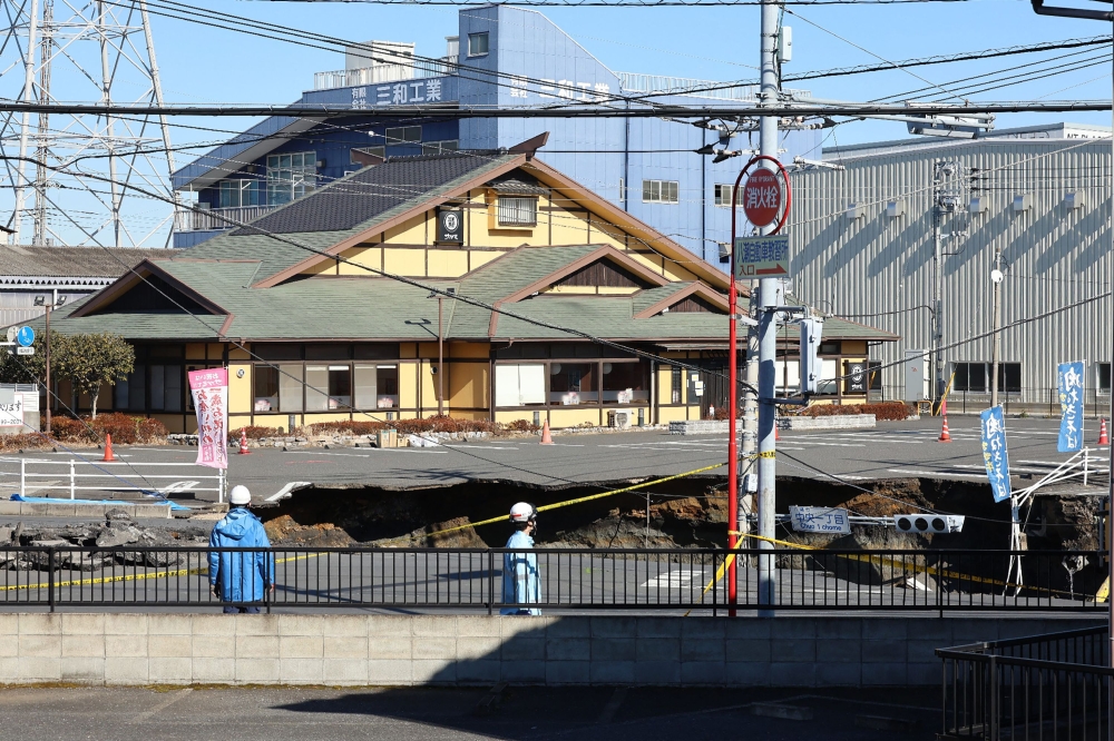 This photo shows a general view of a collapsed road at a prefectural road intersection, in the city of Yashio, Saitama Prefecture on January 30, 2025. — AFP pic