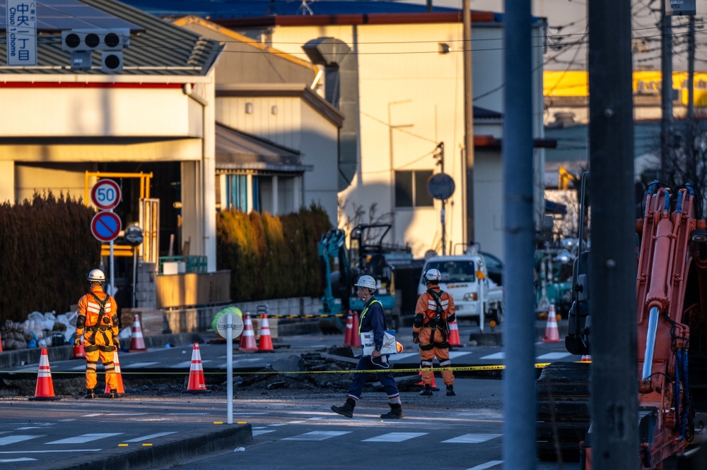 Rescue operations continue for a truck driver after his vehicle plunged into a sinkhole at in Yashio, Saitama Prefecture on January 30, 2025. — AFP pic